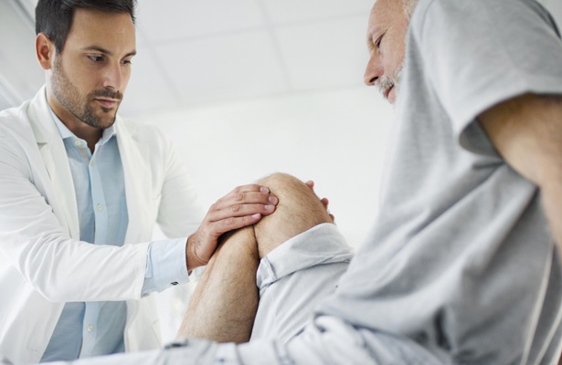 doctor examing knee